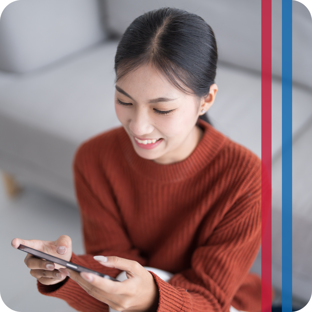 woman using smart thermostat on phone