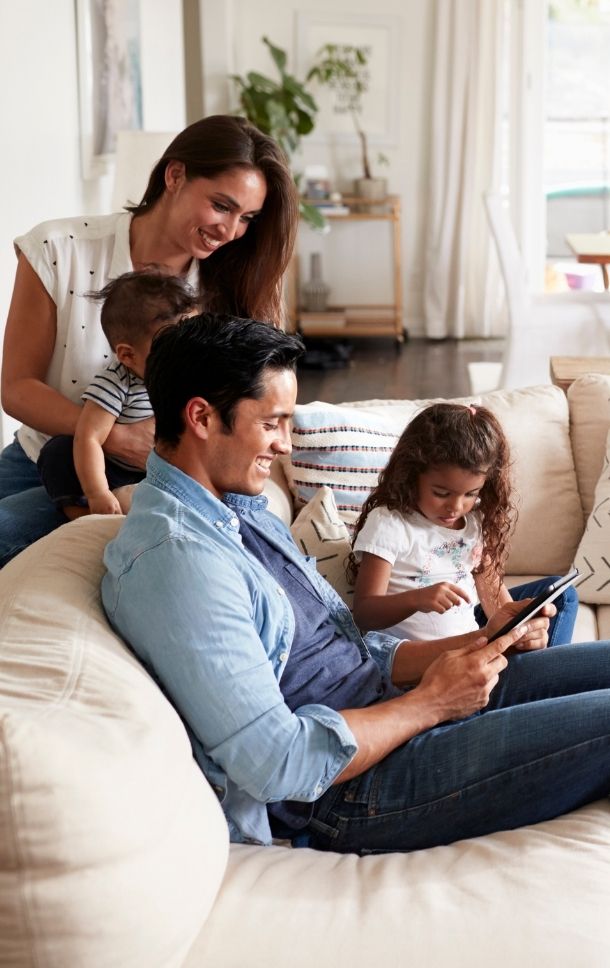 happy family looking at tablet together at home