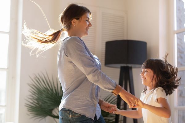 mother and child dancing at home