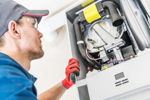 HVAC tech inspecting boiler