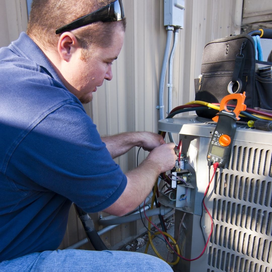 HVAC tech maintaining system