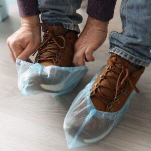 technician putting shoe covers on