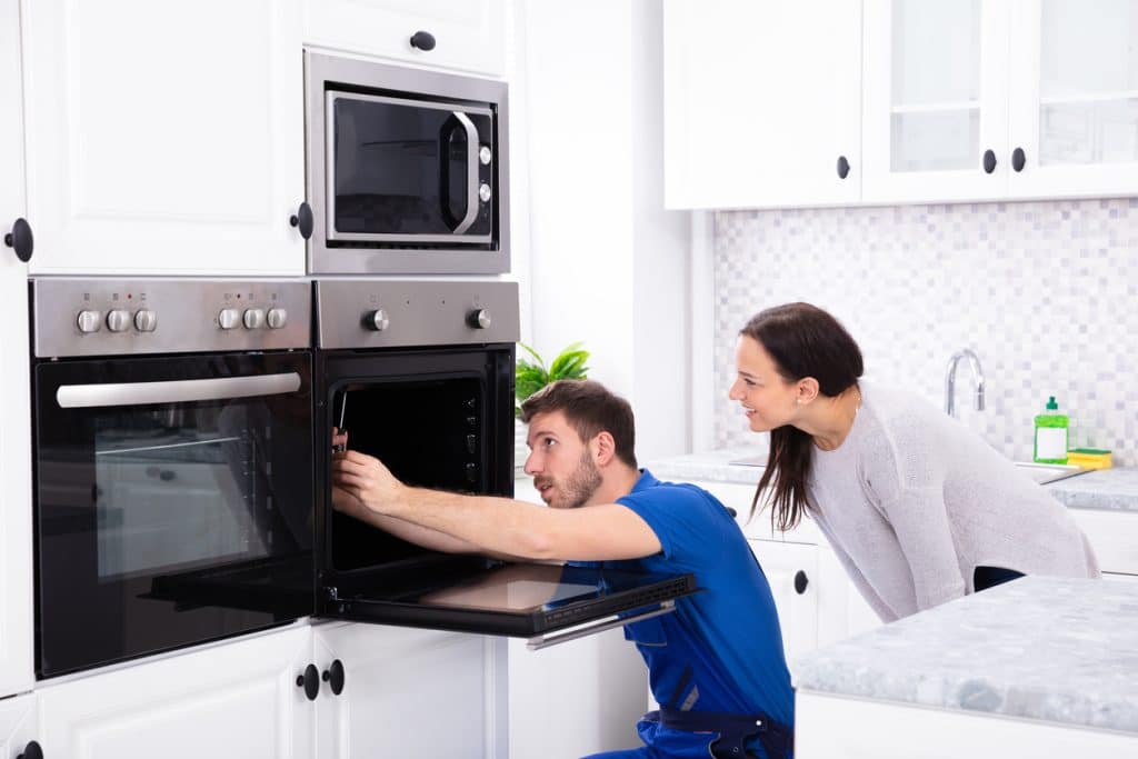 Technician Fixing Oven